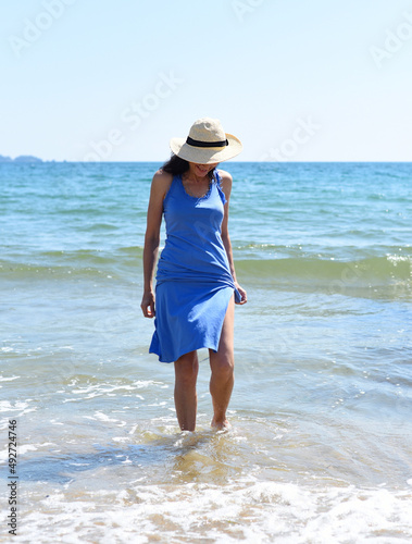 45 years old Russian woman standing in Japanese sea and looking away