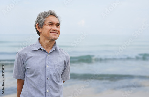 portrait a happy senior man smile and look forward at the beach, concept elderly people lifestyle,travelling,resting,holiday,quality of life etc © Verin
