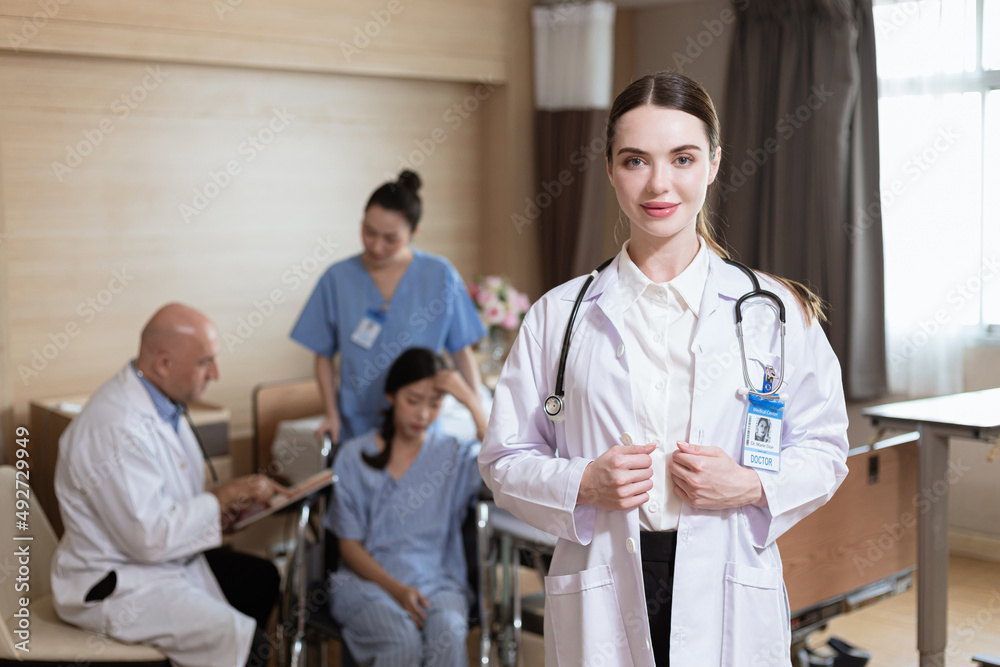 beautiful female doctor standing for portrait Doctor's background with patients and medical students