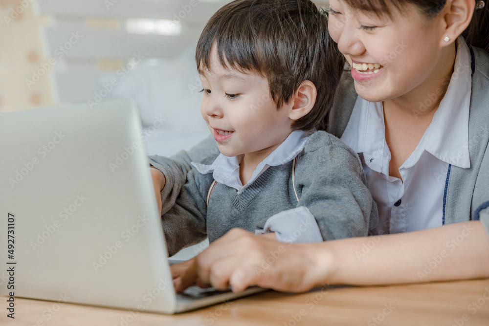 parent and son using laptop parent and son using laptop