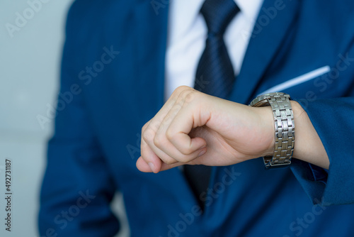 Busy businessman looking at wristwatch, In business time is important ,Portrait of businessman checking time.