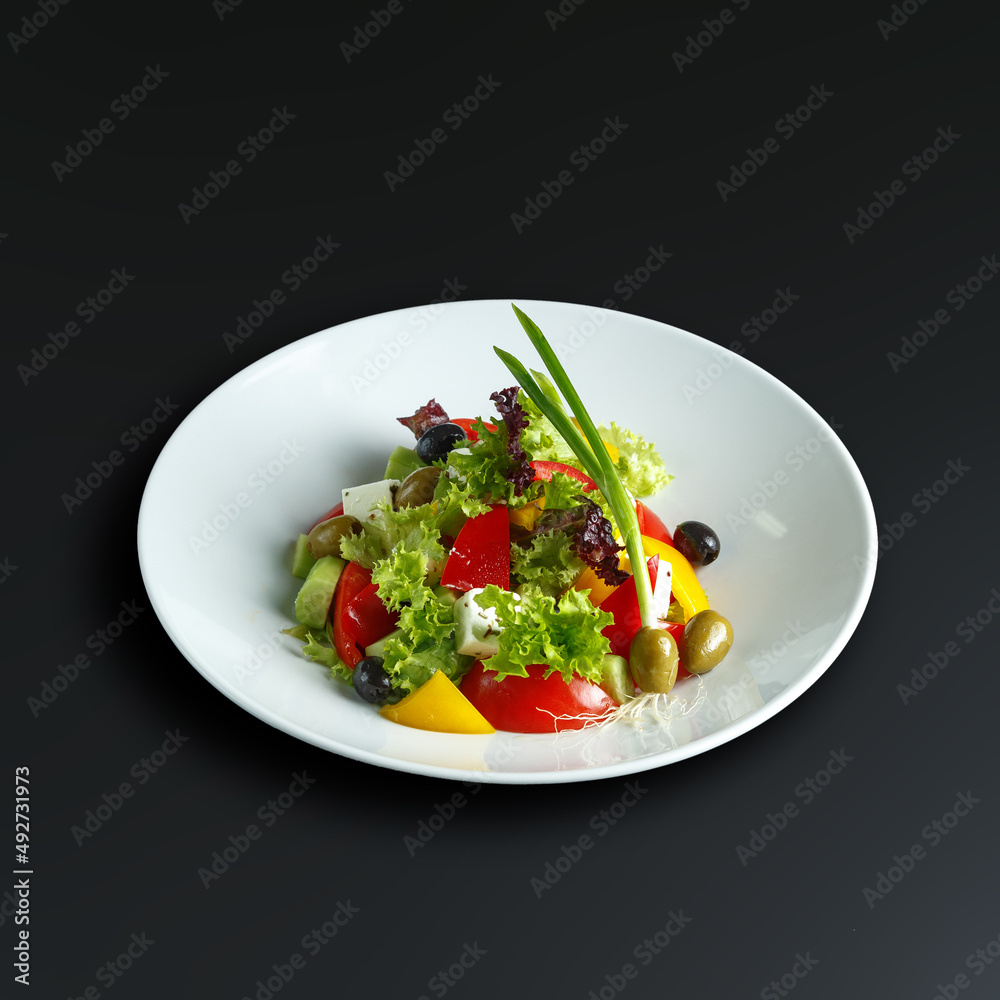 traditional dishes of European cuisine, delicacy, banquet snack. culinary dishes on a white plate on a black background. restaurant service