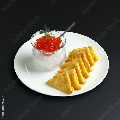 traditional dishes of European cuisine, delicacy, banquet snack. culinary dishes on a white plate on a black background. restaurant service photo