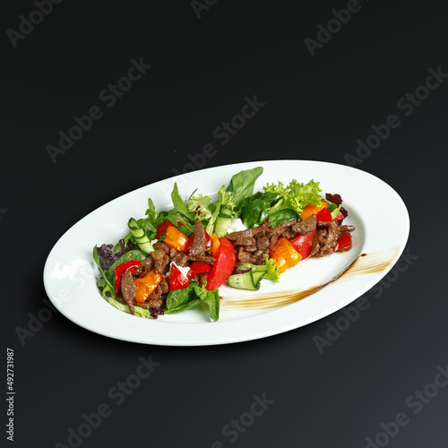 traditional dishes of European cuisine  delicacy  banquet snack. culinary dishes on a white plate on a black background. restaurant service