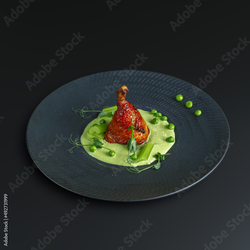 traditional dishes of European cuisine, delicacy, banquet snack. culinary dishes on a white plate on a black background. restaurant service photo