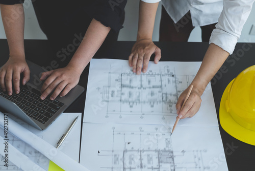 Team of engineers and architects, working team, meeting, discussing construction and drawing construction plans, printing, writing on-site construction sites. Home design concept