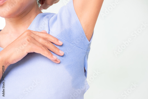 Woman wet shirt underarm close up. problem Armpit sweat stains and strong body odor. hyperhidrosis sweating.hygiene for good health concept. photo