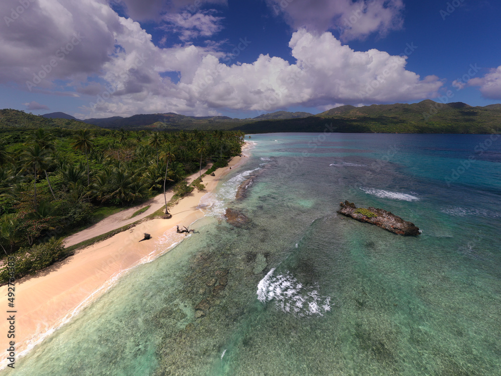 Fototapeta premium a tropical island with a snow-white beach and a turquoise sea in the Dominican Republic filmed from a drone 