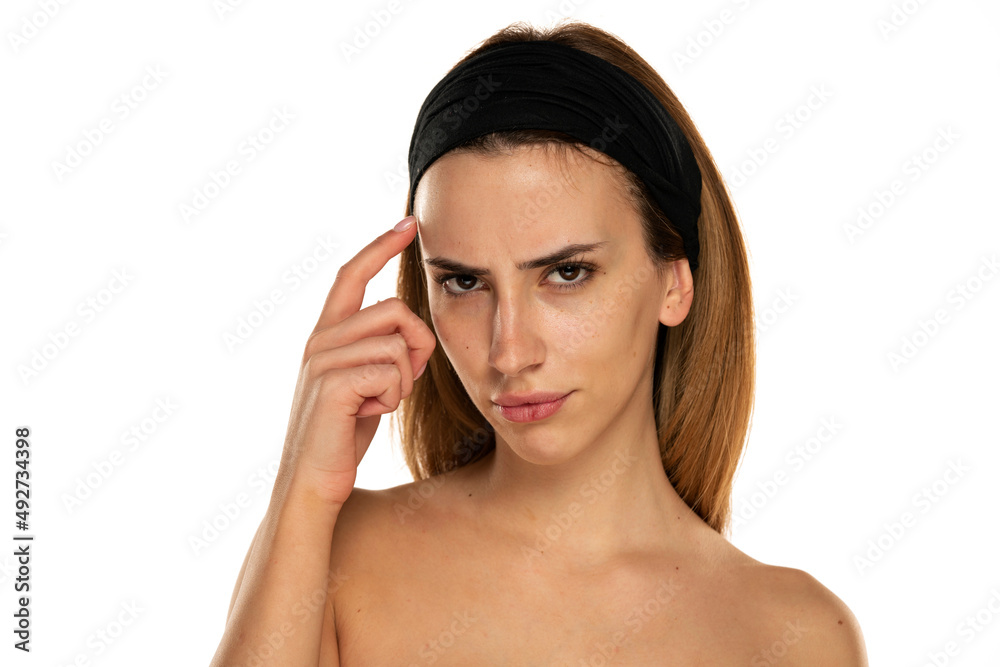 young woman without makeup looking with distrust and thinking young woman without makeup looking with distrust and thinking