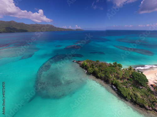 a tropical island with a snow-white beach and a turquoise sea in the Dominican Republic filmed from a drone 