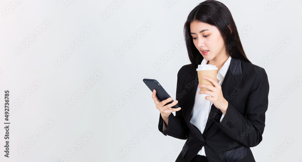 Entrepreneur pretty woman holding coffee cup and touching screen on smart phone mobile, attractive asian people drink beverage smart, Technology communication lifestyles concept. Entrepreneur pretty woman holding coffee cup and touching screen on smart phone mobile, attractive asian people drink beverage smart, Technology communication lifestyles concept.