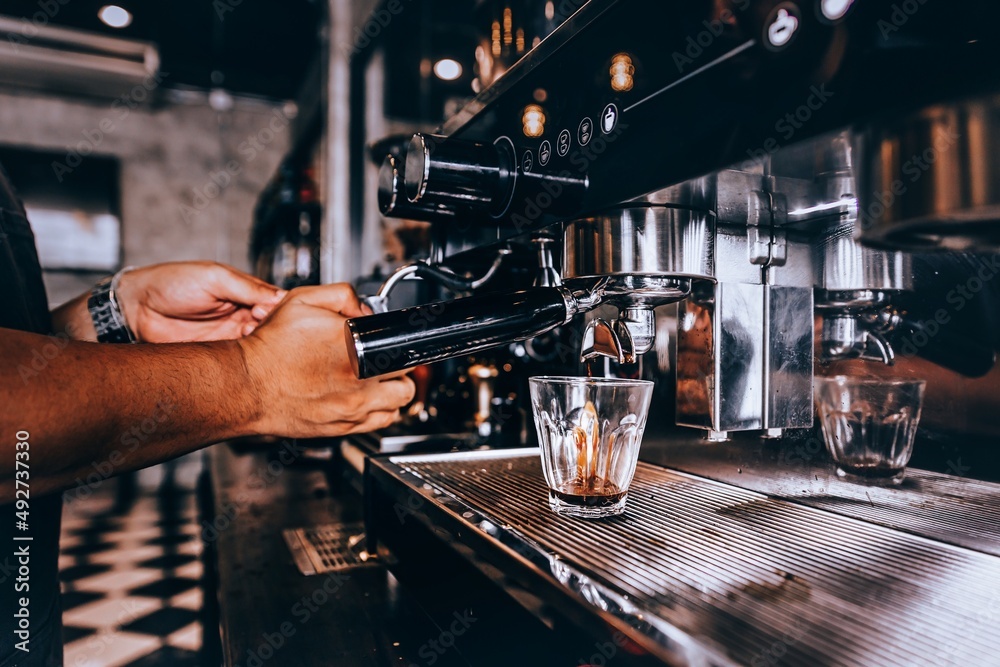 Fotografie Barista making coffee with coffee machine in cafe.
