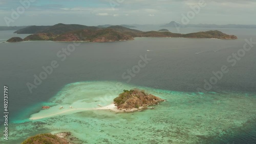 aerial seascape island with white beach. Bulog Dos, Philippines, Palawan. tourist boats on coast tropical island. Seascape bay with turquoise water and coral reef. photo