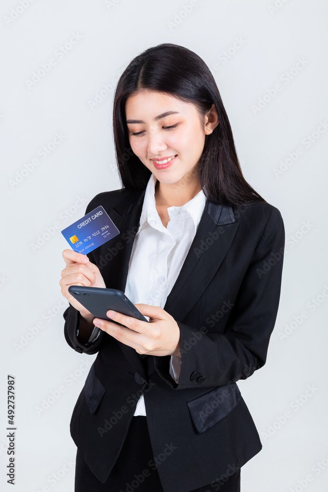 asian business woman wearing office clothing hands show credit card and use smart phone mobile, credits card and payment concept. asian business woman wearing office clothing hands show credit card and use smart phone mobile, credits card and payment concept.