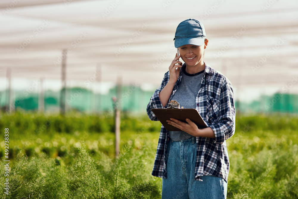 Im calling to give you the numbers.... Cropped shot of an attractive young  female farmer making a phonecall while working on her farm. Stock Photo |  Adobe Stock