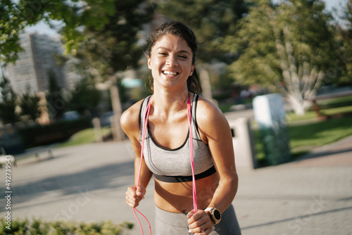 Fit athlete woman in sportswear outdoors. Young woman resting after training..