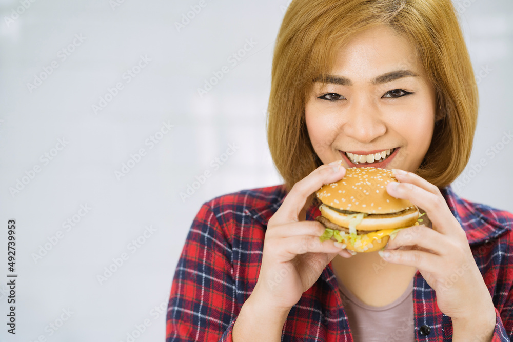 young pretty girl enjoy eating fast food burger unhealthy, american calories fat meal Junk food . young pretty girl enjoy eating fast food burger unhealthy, american calories fat meal Junk food .