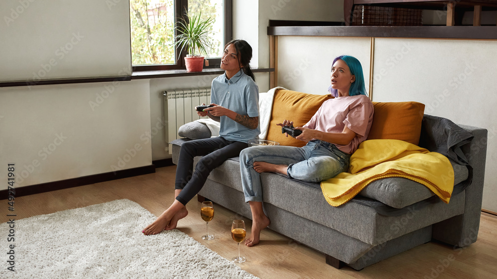 Girlfriends enjoy playing video games on vacation Girlfriends enjoy playing video games on vacation