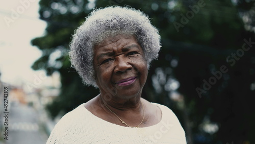 Portrait of a Brazilian senior woman in 80s standing outside