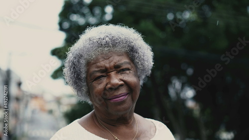 Portrait of a Brazilian senior woman in 80s standing outside