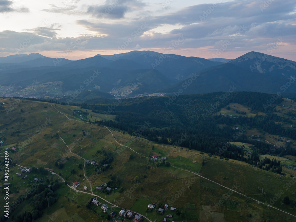 Fototapeta premium Sunset over the mountains in the Ukrainian Carpathians. Evening. Aerial drone view.