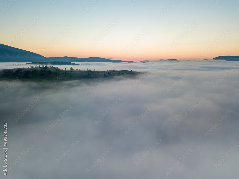 Morning fog in the Ukrainian Carpathians. Aerial drone view.