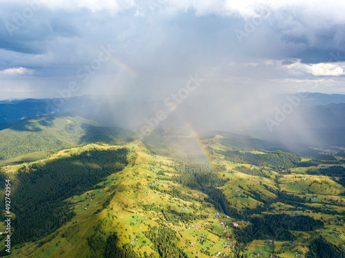 Rainbow in the mountains of the Ukrainian Carpathians. Aerial drone view. © Sergey