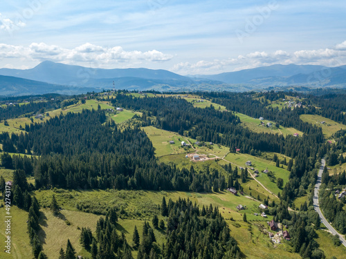 Green mountains of Ukrainian Carpathians in summer. Sunny day  rare clouds. Aerial drone view.