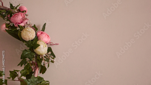 Pink flowers on a pink-beige background. An element for your design. Copy space.
