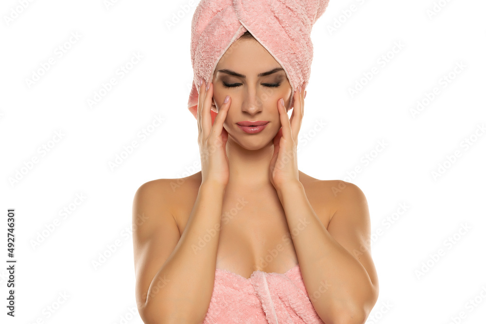 Young beautiful woman posing with a towel on her head Young beautiful woman posing with a towel on her head