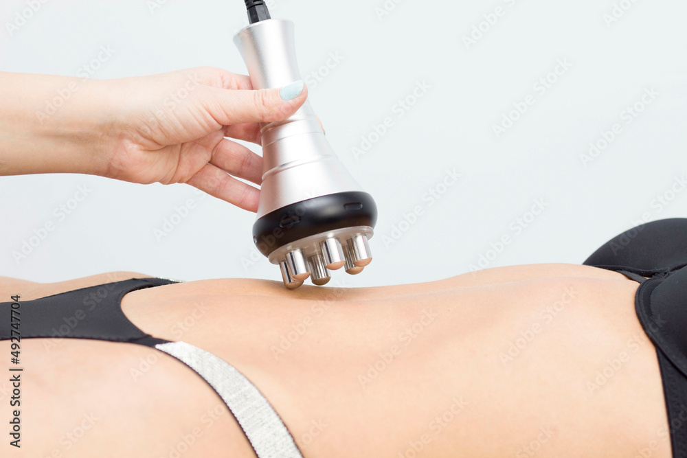 procedure removing cellulite on female abdomen, cavitation belly massage.  Ultrasonic massage for weight loss. Correction of female figure without  surgical intervention. Closeup of the tummy. Stock Photo | Adobe Stock