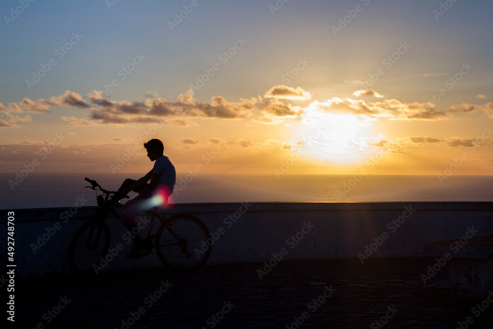 Fototapeta premium Boy on bike during sunset
