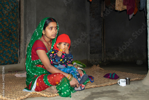 mother feeding her child, mother and child, rural, India photo