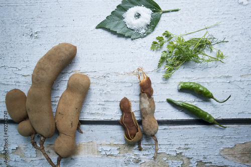 Some raw tamarind with tamarind leaf photo