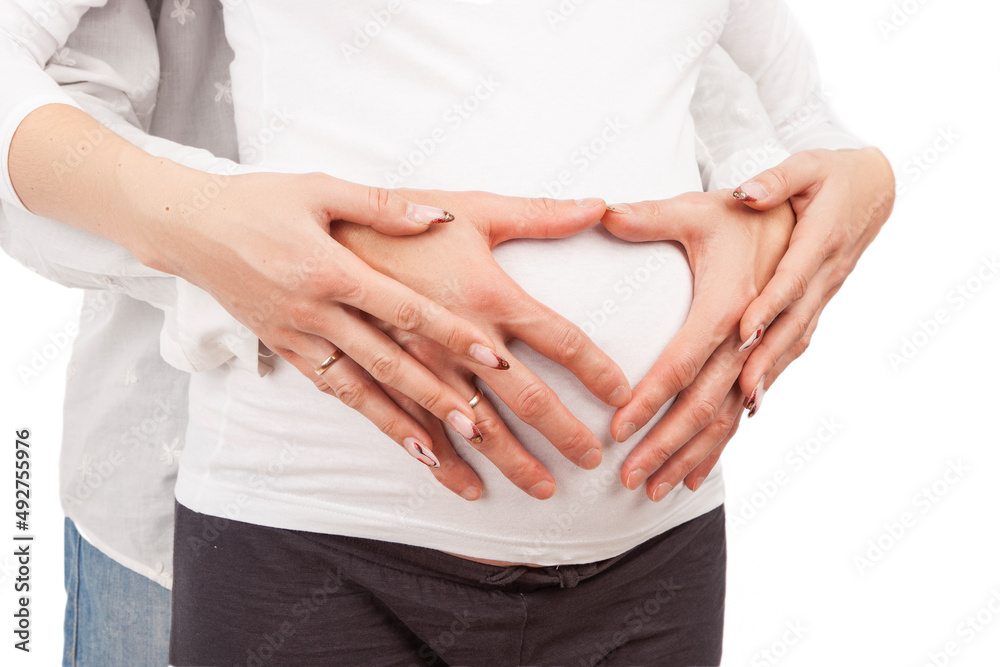 Closeup of Hands of Caucasian Couple Over Pregnant Womn Belly Over White Background
