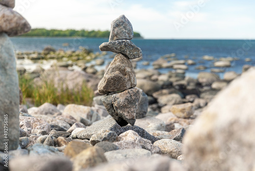 nature, harmony and balance - close up of stone pyramids or towers on beach © Syda Productions