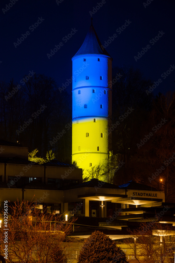 Obraz premium Die Stadt Biberach an der Riß beleuchtet den Weißen Turm zum Zeichen der Solidarität mit der Ukraine in den Nationalfarben der Ukraine