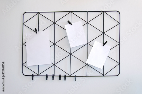 Moodboard with white list and black triangular lattice on grey background