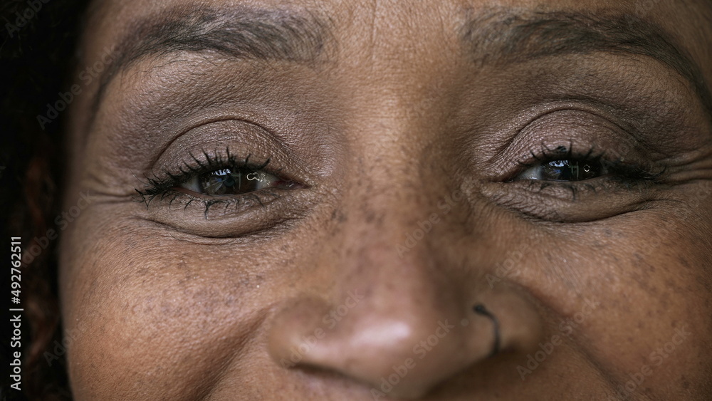Macro close-up eyes person smiling a black woman happy expression Macro close-up eyes person smiling a black woman happy expression