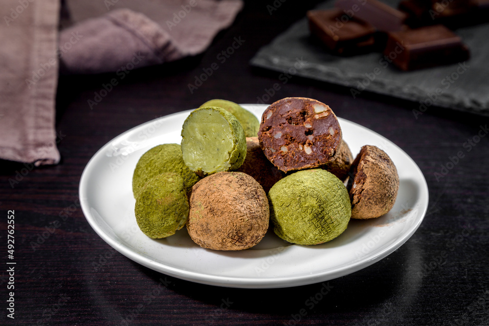 Truffle sweets with dark chocolate and white chocolate with matcha tea Truffle sweets with dark chocolate and white chocolate with matcha tea