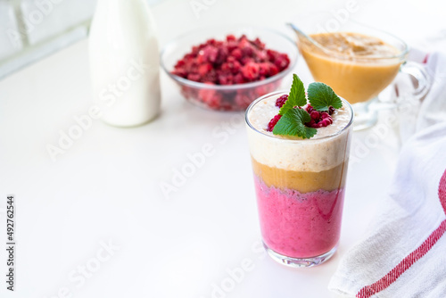 Delicious layered yogurt dessert with applesauce, raspberries and banana.
