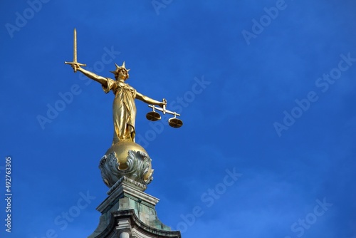 Justice statue atop court in London