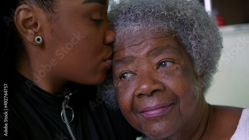 A teen granddaughter taking care of grandmother giving help and support