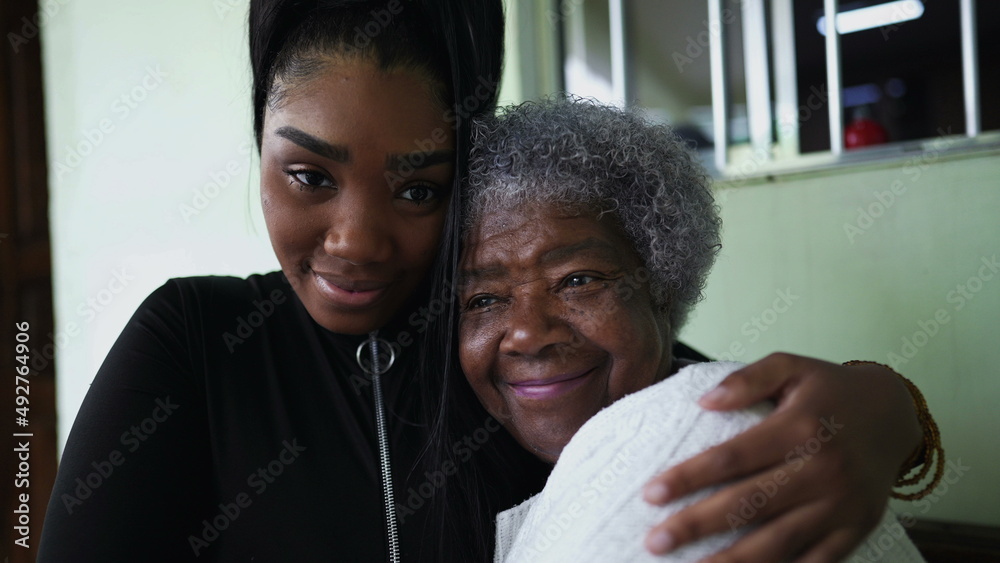 A teen granddaughter embracing grandmother a black girl embraces grandparent A teen granddaughter embracing grandmother a black girl embraces grandparent
