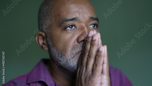 A senior black man praying to God seeking HOPE and FAITH photo