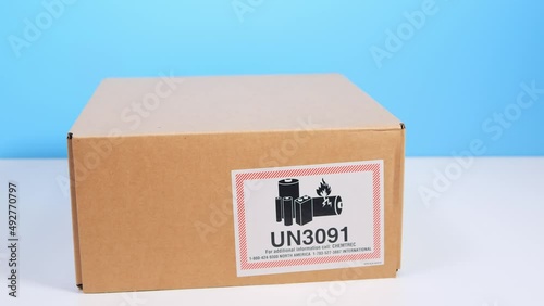 Courier delivery of goods with lithium metal batteries contained in equipment, or li ion batteries packed with the equipment (including lithium alloy batteries). Craft cardboard box with sign 'un3091'