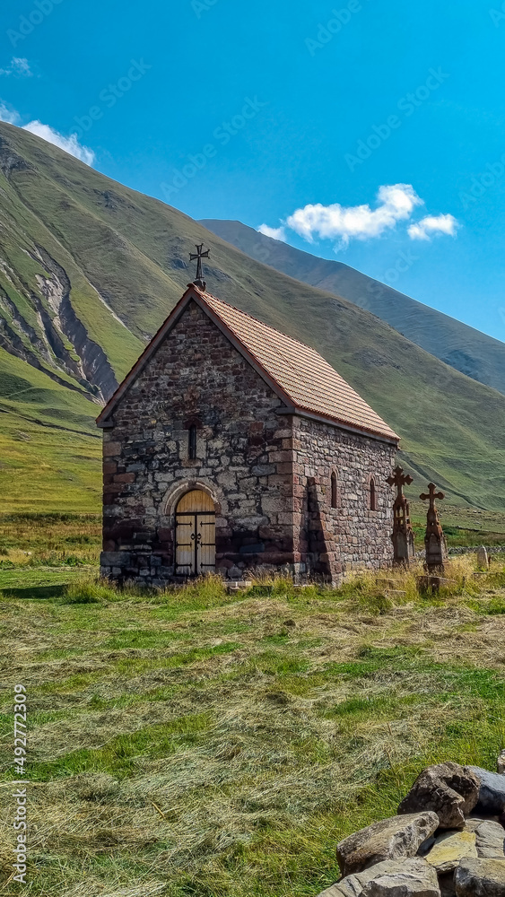 An old and ancient stone church in Truso Valley near the Ketrisi Village Kazbegi District, Mtskheta-Mtianet in the Greater Caucasus Mountains, Georgia.Close to Russian Border.Abano monastery.Grassland