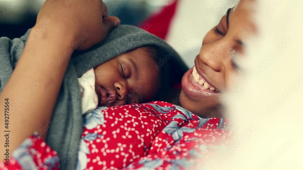 Mother with her newborn baby at home
