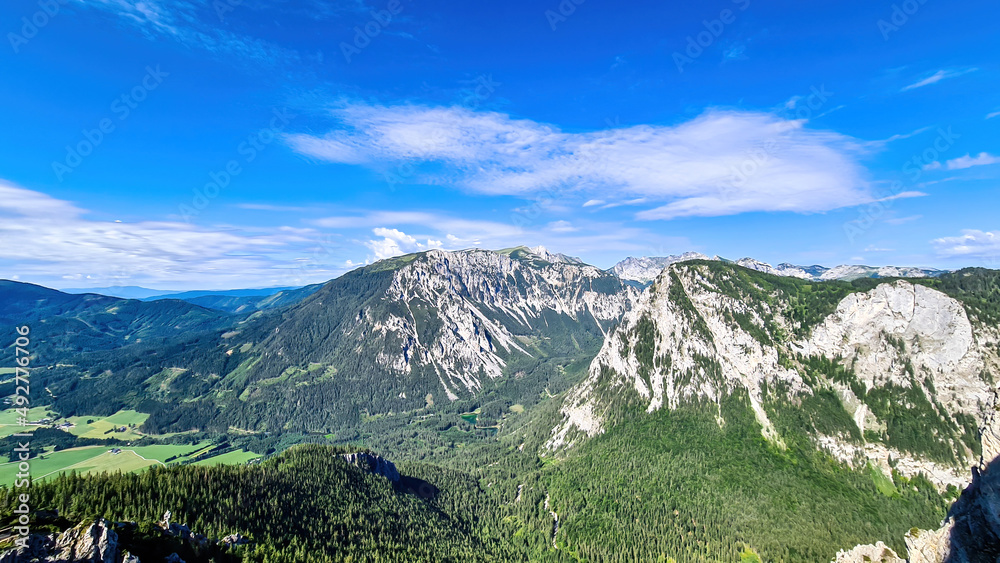 A panoramic view on the Alpine mountain chains in Styria,Austria,Hochschwab region.The slopes are partially overgrown with bushes,higher parts baren. A sunny day.Serenity,Wanderlust.Hiking in Alps