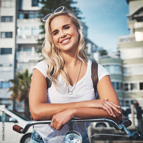 Dont let anyone steal your sunshine. Cropped shot of a beautiful young woman out with her bicycle.